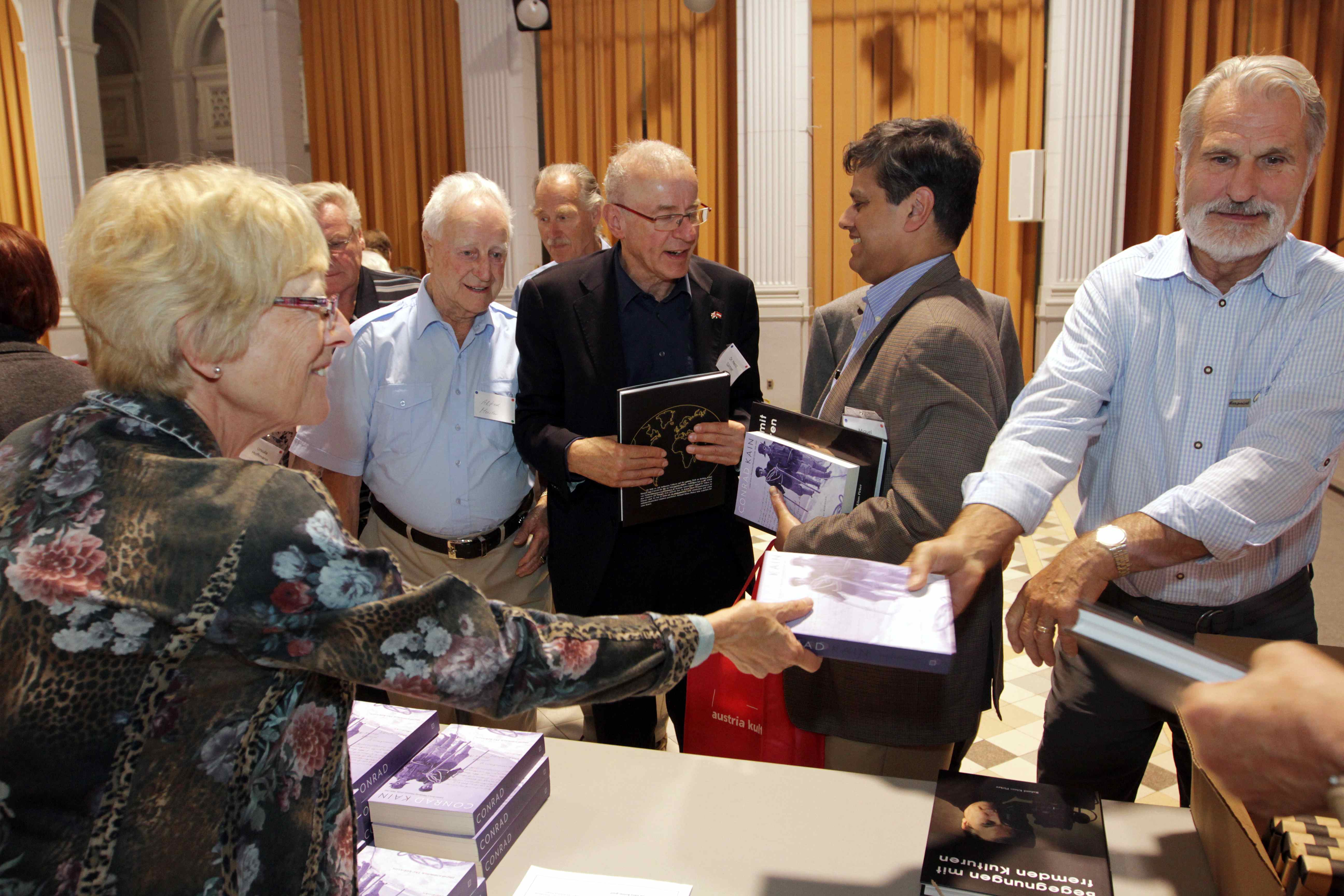 Christine Welling distributes copies of books by Conrad Kain and Roland Pirker